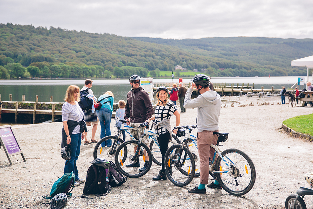 people on bikes by a lake